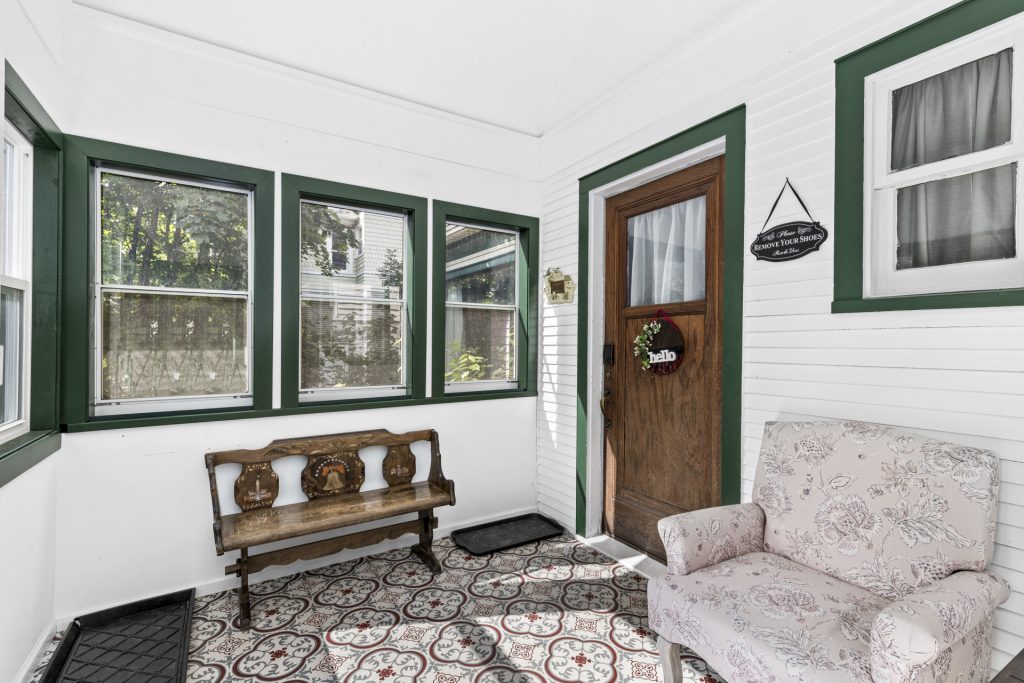 The enclosed front porch is a sunny spot to land, kick off your shoes, and chat.