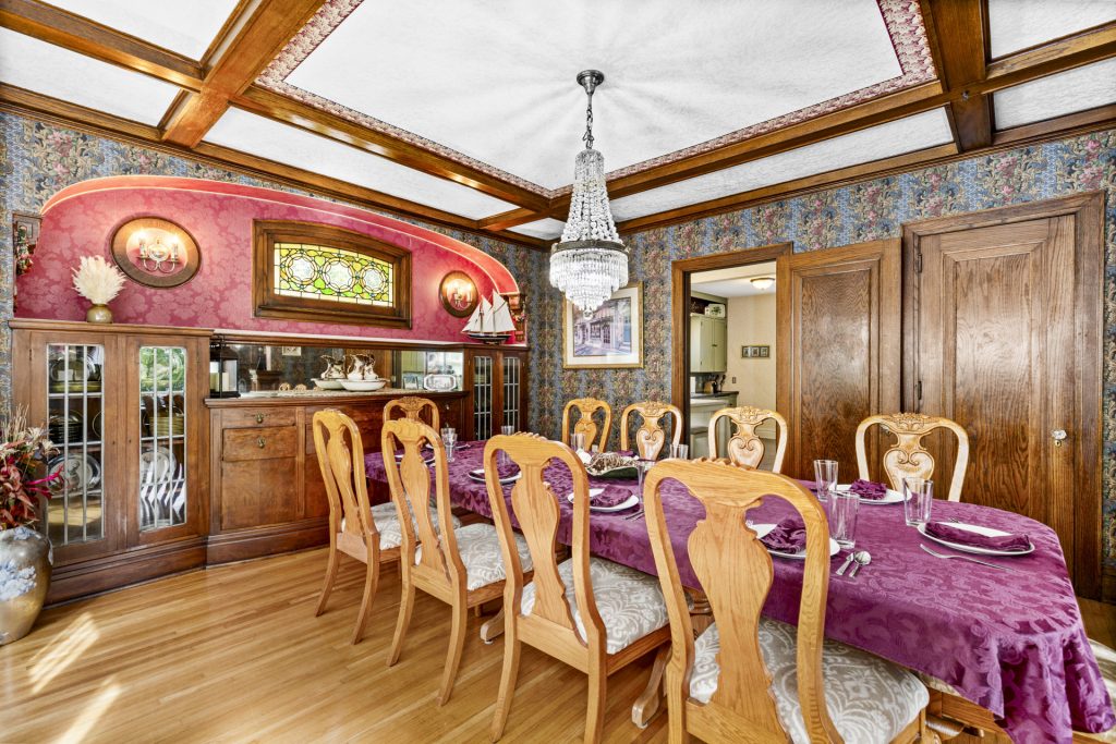 The dining room seats ten under the original chandelier.