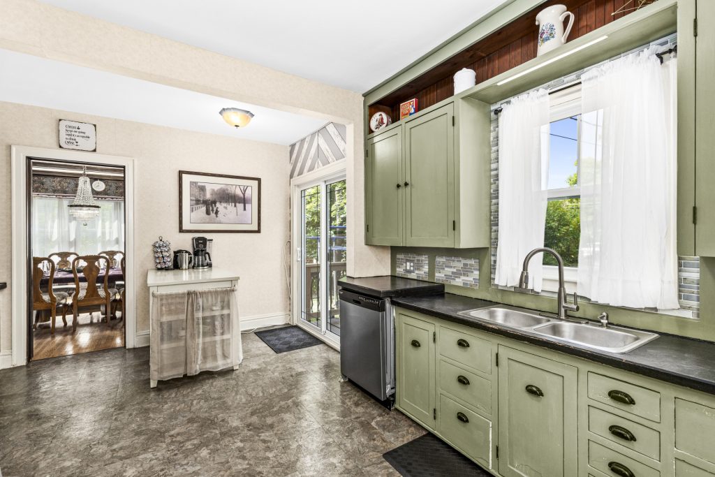 Kitchen sink with nice view of backyard, along with a dishwasher.