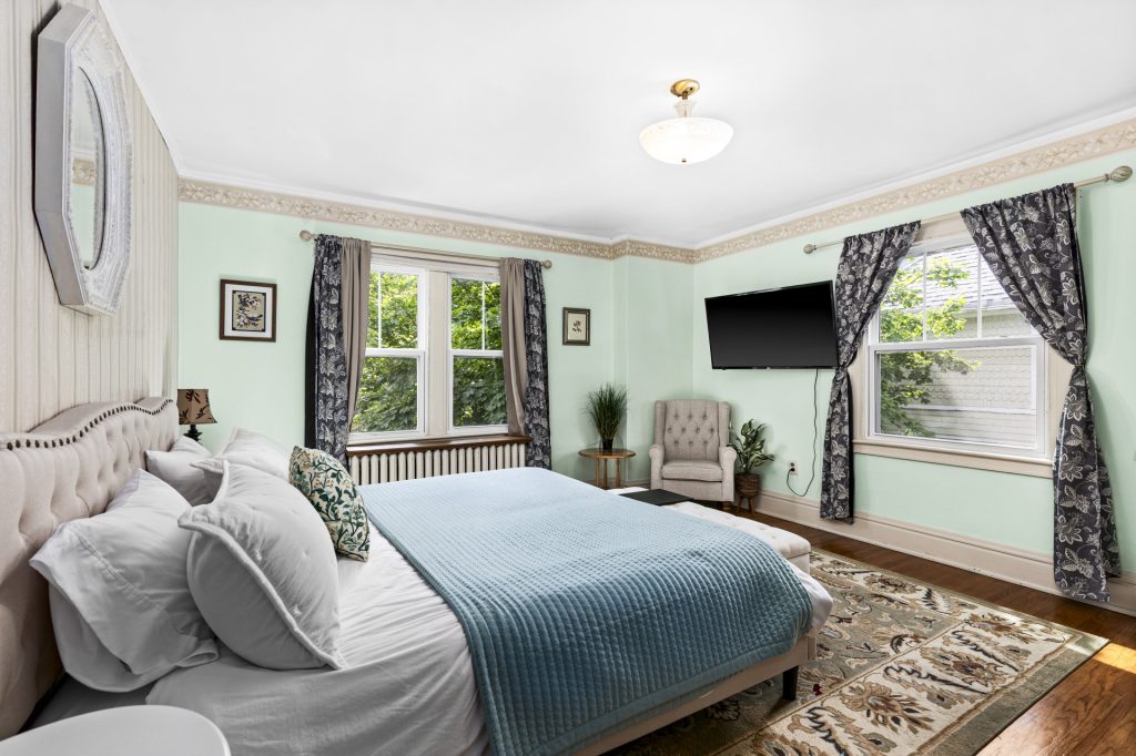 Spacious bedroom with a plush king bed and a smart TV.