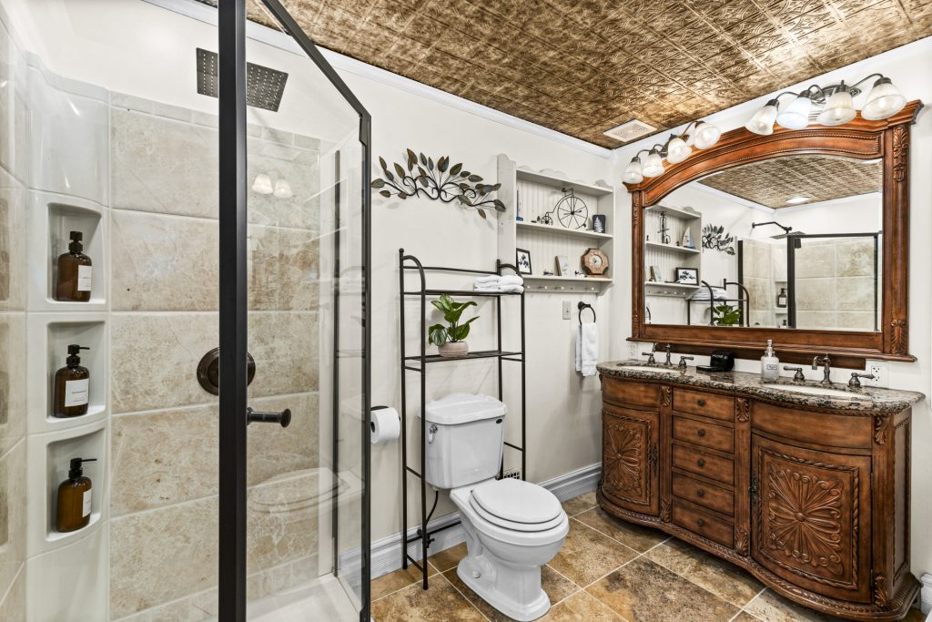 Full bath with a walk-in shower and a beautiful wood vanity.