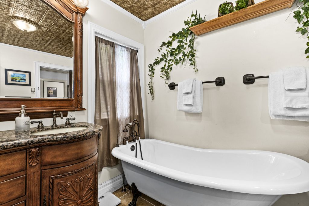 Soak in the clawfoot tub under the pressed tin ceiling.