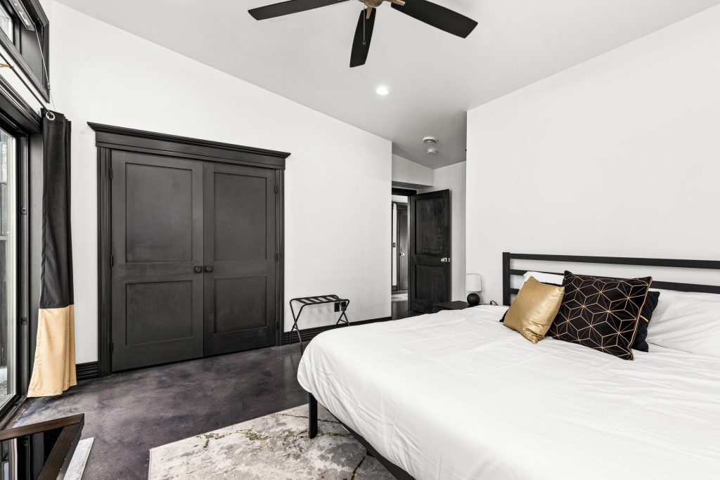 The large master bedroom features a king bed and outdoor access.