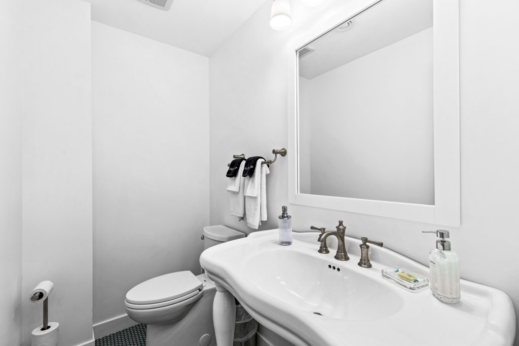 A tastefully appointed half bath offers guests a clean and convenient touch of comfort.