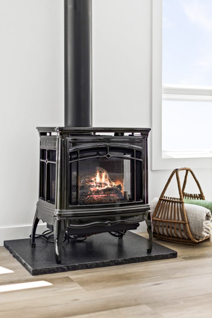The gas fireplace sets a cozy scene with the ease of a remote, perfect for unwinding after a day on the shore.