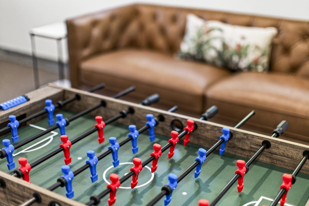 Foosball and a handsome leather sofa make the game room a natural gathering spot.