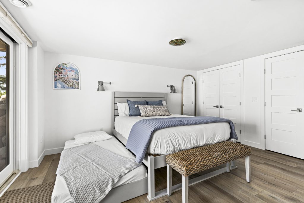 The blue bedroom's twin trundle pulls out for extra guests, with lakeside decor and plenty of natural light.