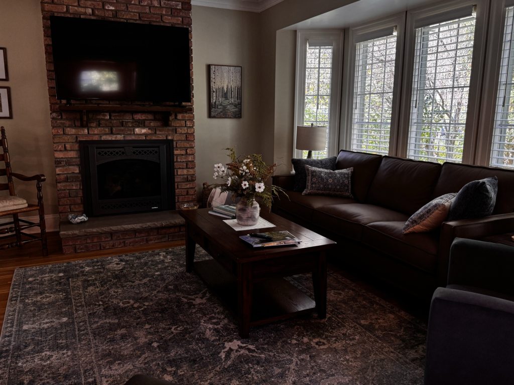 Living room with gas fireplace and TV above.