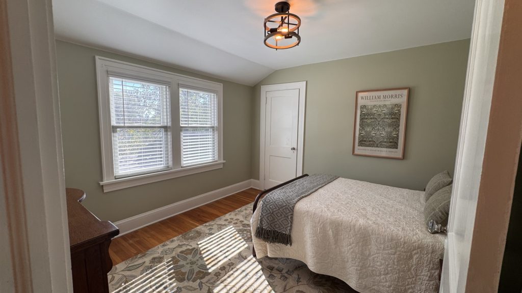 Garden Bedroom on second floor. Window overlooking backyard/garden.