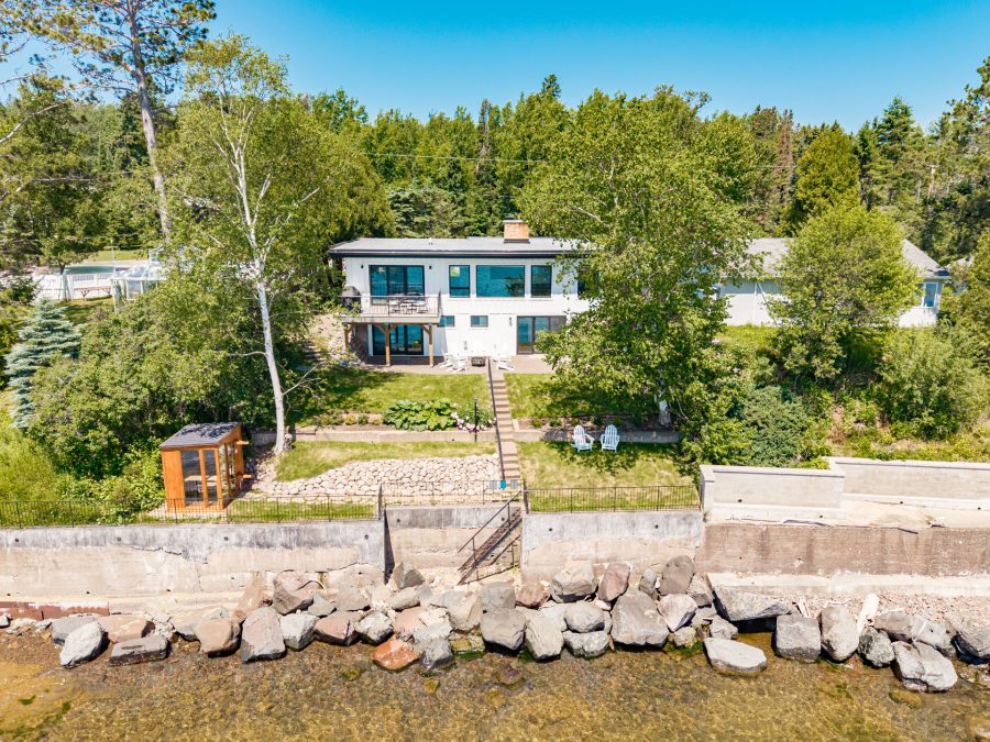 Perched on Lake Superior, this modern retreat pairs clean architectural lines with a private patio and wide open water views.