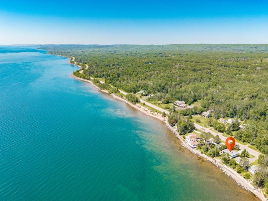 The turquoise waters of Lake Superior stretch to the horizon, showcasing the pristine coastline that surrounds your stay.