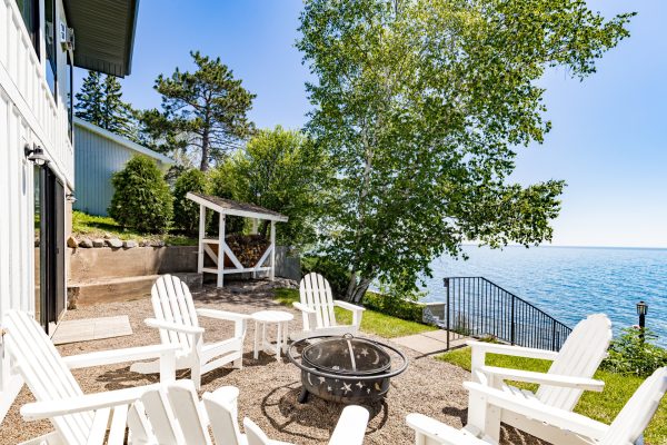 Gather around the lakeside fire pit, framed by Adirondack chairs, for evenings under the open sky.