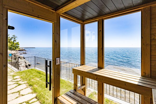 Unwind in the cedar sauna, where floor to ceiling windows frame uninterrupted views of Lake Superior right from the bench.