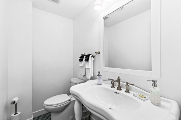 A tastefully appointed half bath offers guests a clean and convenient touch of comfort.