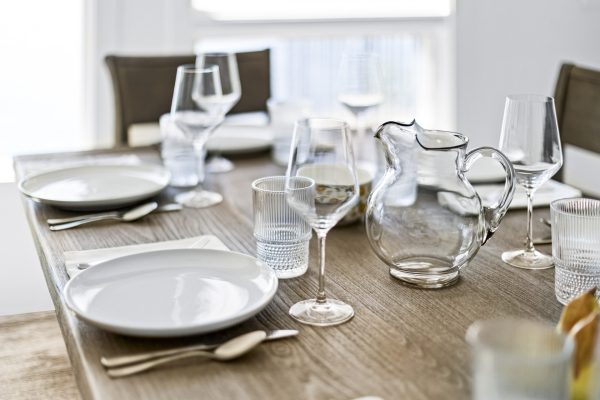Every meal feels elevated with thoughtful place settings and glassware ready for your stay.