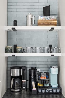 A curated collection of mugs sits ready for cozy mornings by the water.