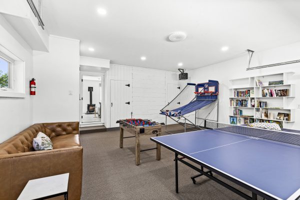 The game room comes loaded with a ping pong table, basketball game, foosball, and a comfy spot to hang out.