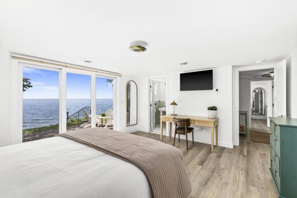Wake up to Lake Superior in this serene bedroom, where expansive windows bring the water right to your bedside.