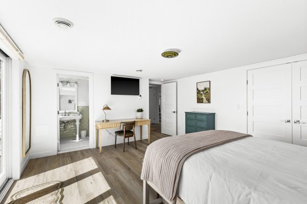 The green bedroom also includes a twin trundle and a dedicated workspace, ideal for families or remote work.