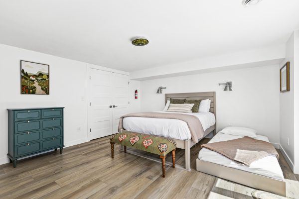 The green bedroom's twin trundle pulls out for extra guests, with charming decor and plenty of natural light.