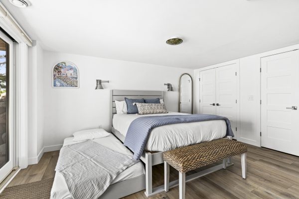 The blue bedroom's twin trundle pulls out for extra guests, with lakeside decor and plenty of natural light.