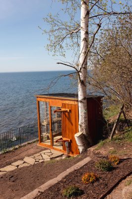 Private electric sauna with floor-to-ceiling windows overlooking Lake Superior.